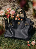 Black Folded-Flap Handbag with Gold-Tone Hardware — hero