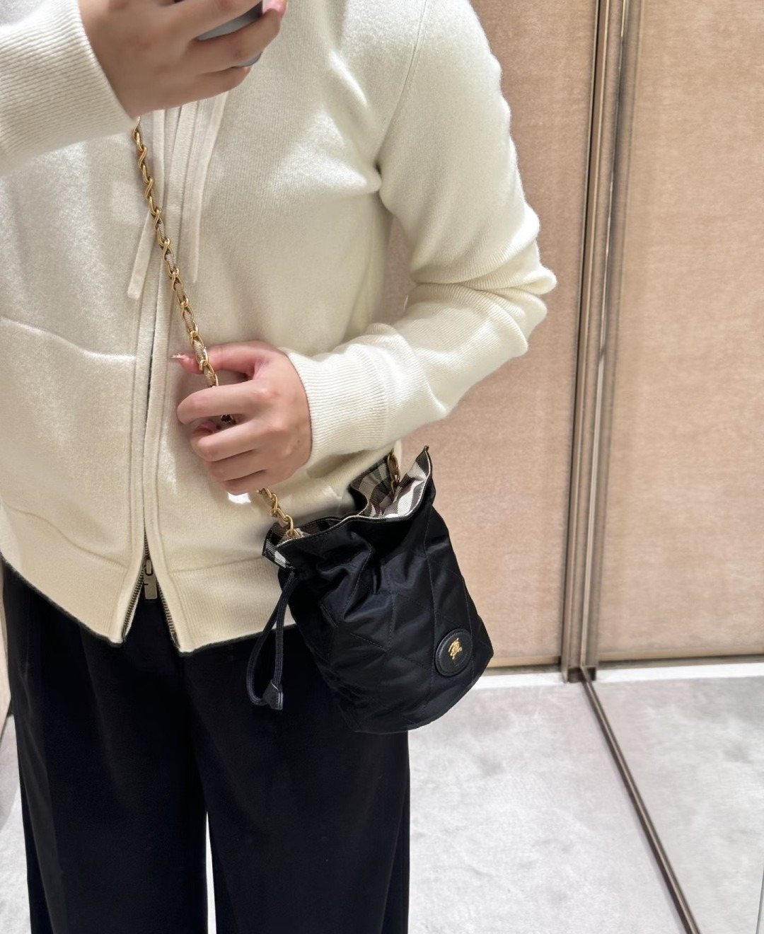 Black Quilted Chain-Strap Bucket Bag — model