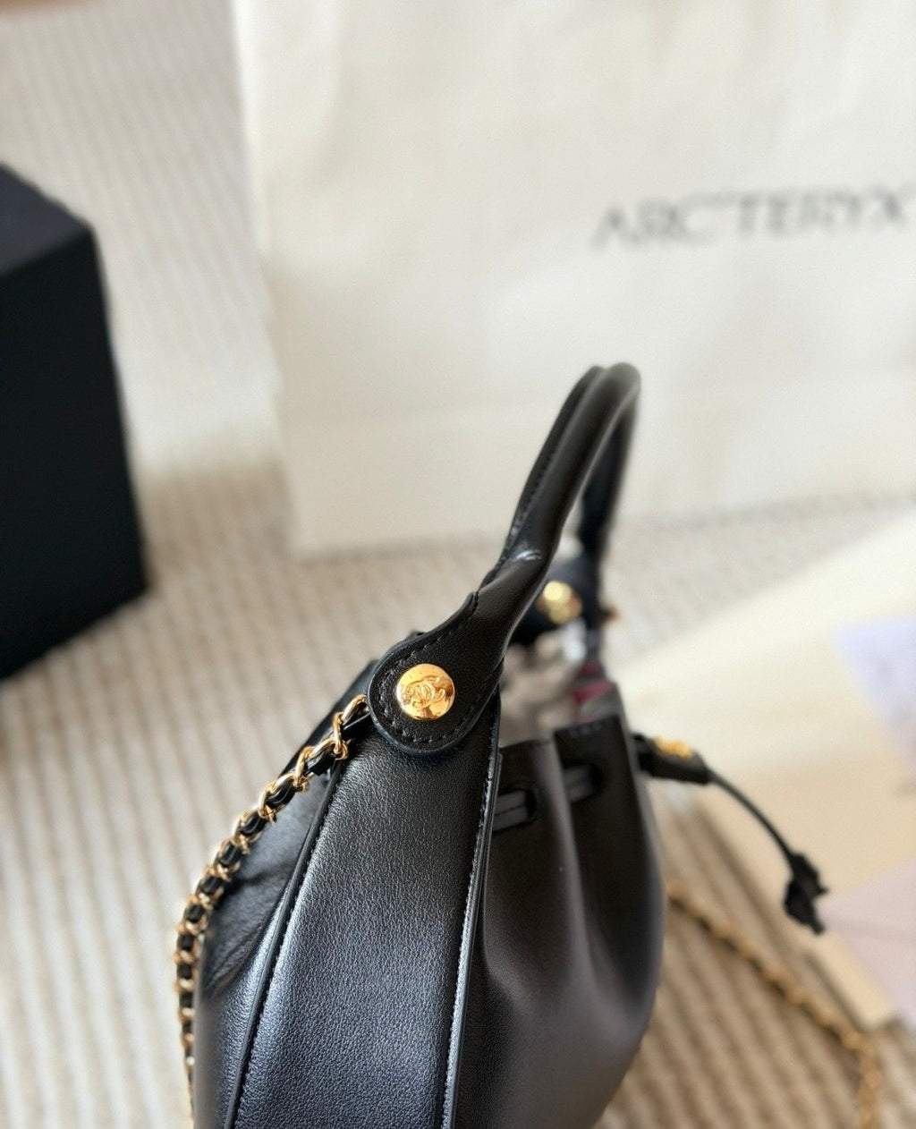 Chanel Black Rounded Drawstring Top-Handle Bag — side